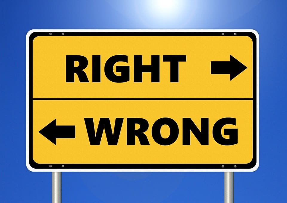 A sign reading 'right' and 'wrong' pointing in two opposite directions